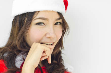 Beautiful young santa clause woman in christmas clothes smiling . isolated on white backgroundの写真素材