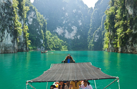 SURAT THANI, THAILAND - NOV 24, 2012 : Tourist arrival by long tail boat in the morning at...