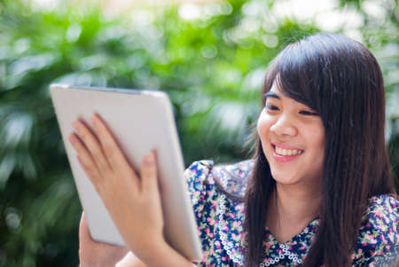 Young Asian woman using a pad PCの写真素材