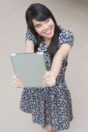 Young Asian woman using a pad PCの写真素材