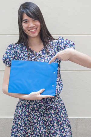 Smiling woman holding blank billboard.の写真素材