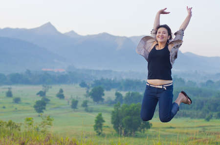 Pretty woman with opened arms expressing freedomの写真素材