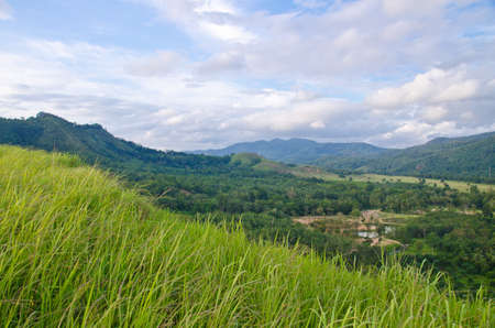 Grass Mountain and blue sky background located in Ranong, Thailandの写真素材