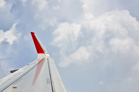 view from airplane window - airplane wing on the clouds