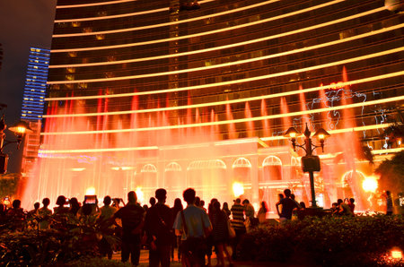 MACAU, CHINA - MAY 9: visitors seeing fountain show at buildings of Macau Wynn hotel on May, 2013, Wynn hotel casino is the landmark of Macau city in China.のeditorial素材