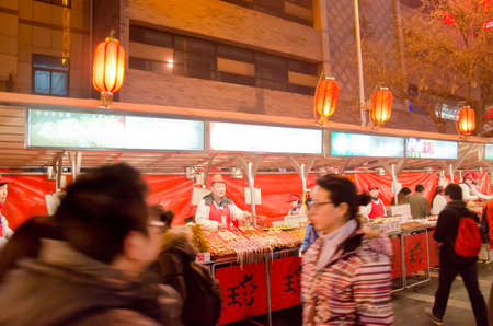 BEIJING-FEB 20: Food vendors at the Donghuamen Night Market near Wangfujing Street on February 20, 2012 in Beijing, China. Wangfujing is a 700-year-old street.のeditorial素材