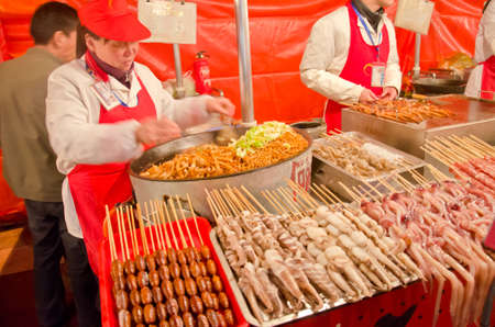BEIJING-FEB 20: Food vendors at the Donghuamen Night Market near Wangfujing Street on February 20, 2012 in Beijing, China. Wangfujing is a 700-year-old street.のeditorial素材