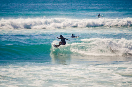 BALI, INDONESIA - OCT 18: Unidentified young man surfing the waves on October 18, 2010. Dreamland beach, Bali, Indonesia. The Dreamland is one of the most popular surfing areas of Bali.のeditorial素材