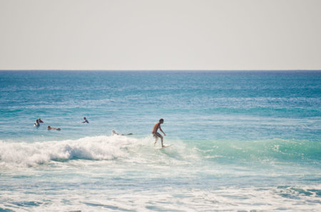 BALI, INDONESIA - OCT 18: Unidentified young man surfing the waves on October 18, 2010. Dreamland...