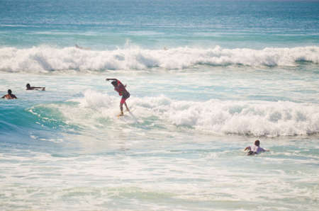 BALI, INDONESIA - OCT 18: Unidentified young man surfing the waves on October 18, 2010. Dreamland beach, Bali, Indonesia. The Dreamland is one of the most popular surfing areas of Bali.のeditorial素材