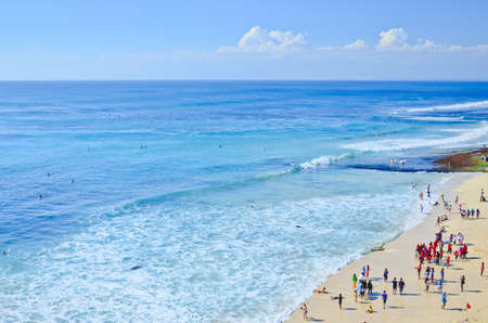 BALI, INDONESIA - OCT 18: Wide sand beach with tourists in sunny day on October 18, 2010. Dreamland beach, Bali, Indonesia. The Dreamland is one of the most popular surfing areas of Bali.のeditorial素材