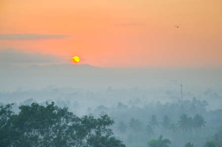 Sunrise view from the top of Borobudur of lust green forest & extinct volcanoes, Java, Indonesia.の写真素材