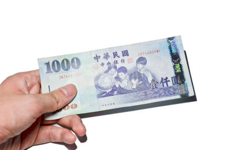 A hand holding a 1000 New Taiwan Dollar bill.の写真素材