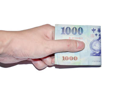 A hand holding a 1000 New Taiwan Dollar bill.の写真素材