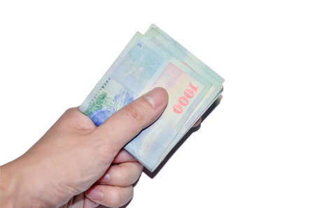 A hand holding a 1000 New Taiwan Dollar bill.の写真素材