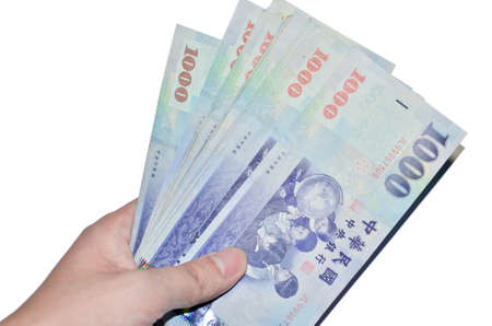 A hand holding a 1000 New Taiwan Dollar bill.の写真素材