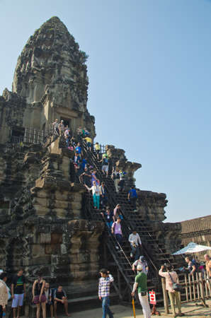 ANGKOR, CAMBODIA - JAN 4: Unidentified tourists climb to a praying tower at Angkor Wat. It is a part of the ancient Khmer complex Angkor, a UNESCO World Heritage Site, Jan 4, 2014, Angkor, Cambodia.のeditorial素材