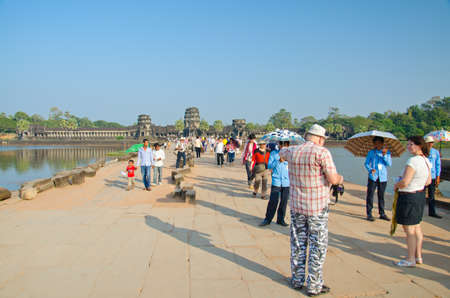 ANGKOR WAT - JAN ,4 : tourists at temple Angkor Wat on Jan 4,2014 in Siem Reap,Cambodia.Templ es of Angkor are the most famous attraction in Cambodia with more than 2 milion visitors per year.のeditorial素材