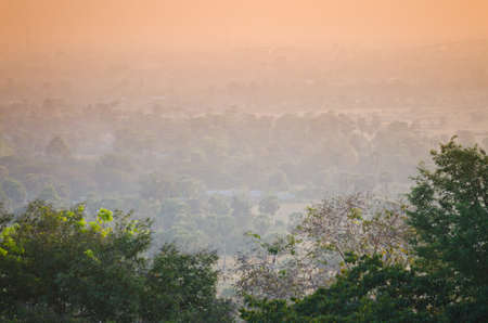 sun set over the jungle and some ruins at Angkor Wat Area in Cambodiaの写真素材
