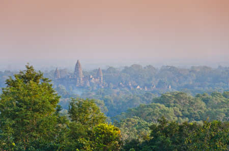 sun set over the jungle and some ruins at Angkor Wat Area in Cambodiaの写真素材