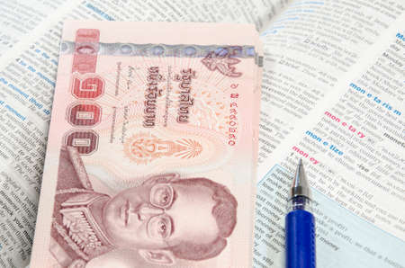 Thai banknote and dictionaryの写真素材