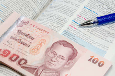 Thai banknote and dictionaryの写真素材