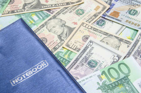 notepad on dollars backgroundの写真素材