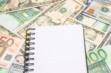 notepad on dollars backgroundの写真素材