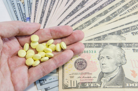 euro banknotes and tablets, symbol photo for costs of medications and health insurance.の写真素材