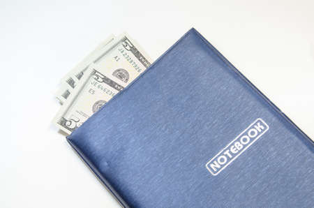 notepad on dollars backgroundの写真素材