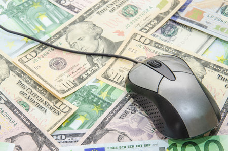 US Dollars and euros and Computer Mouse for backgroundの写真素材