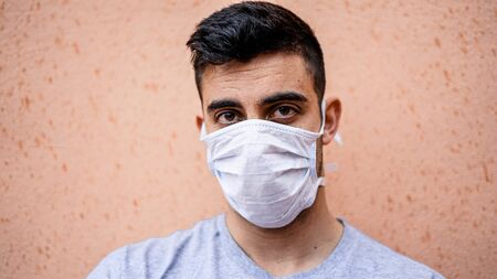 Boy staring with a white mask on to prevent contagion.の写真素材