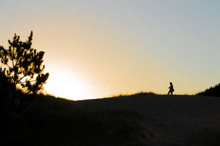 silhouette on the dunes at sunset in Punta del Este, Uruguayの写真素材