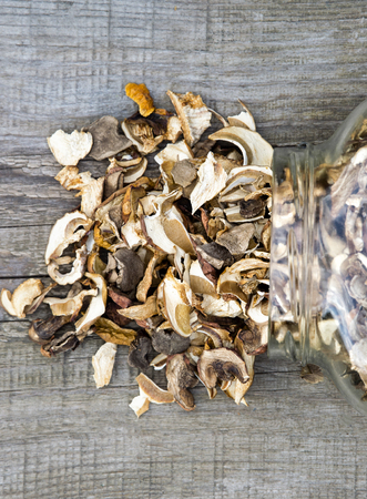 Dried mushrooms in a jar, sliced dried boletus on a old wooden backgroundの写真素材