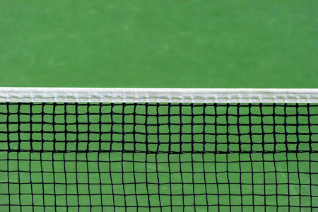 Net of tennis court on green background.の写真素材
