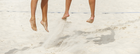 Close-up of feet and legs of a female beach volleyball playerの写真素材