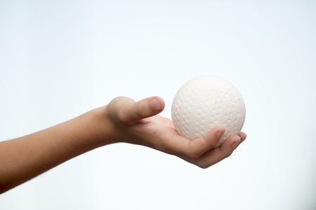 Field hockey white ball in the child's handの写真素材