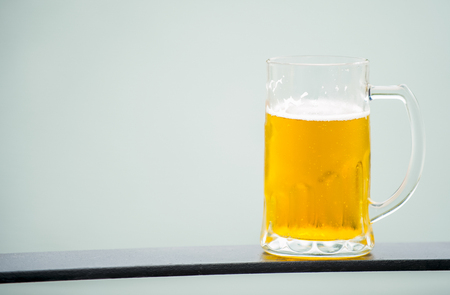 Frosty glass of light beer set isolated on a white backgroundの写真素材
