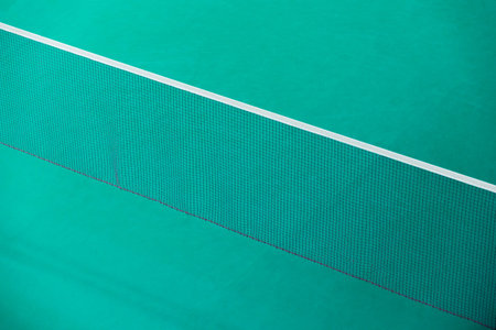 Badminton net indoor on badminton court, closeup view of badminton net with blurry background