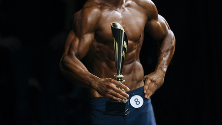 athlete bodybuilder in blue summer shorts winners of bodybuilding competitionsの写真素材