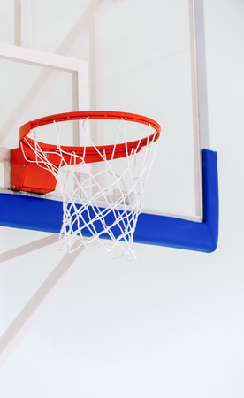 Basketball hoop cage, isolated large backboard closeup, new outdoor court set, blue, red, orange, white back board blank copy space backgroundの写真素材