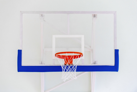 Basketball hoop cage, isolated large backboard closeup, new outdoor court set, blue, red, orange, white back board blank copy space backgroundの写真素材
