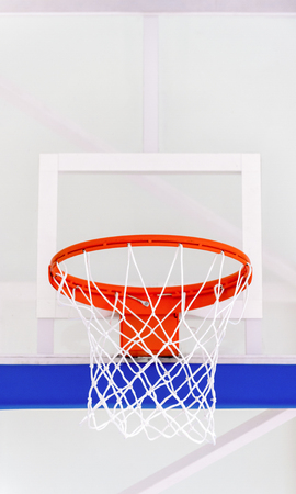Basketball hoop cage, isolated large backboard closeup, new outdoor court set, blue, red, orange, white back board blank copy space backgroundの写真素材
