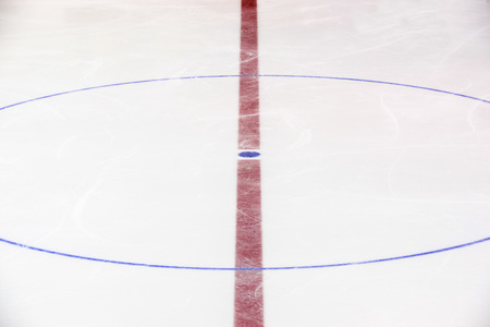 Face off blue spot with red line on hockey rinkの写真素材