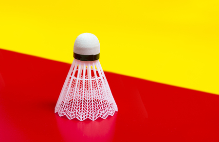 Badminton shuttlecock isolated on the red and yellow backgroundの写真素材