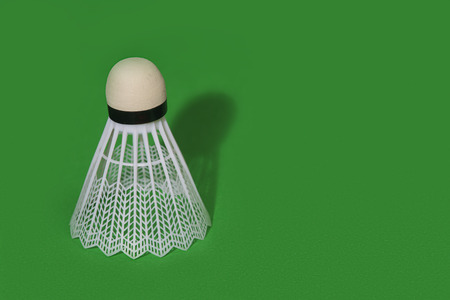 Badminton shuttlecock isolated on the green backgroundの写真素材