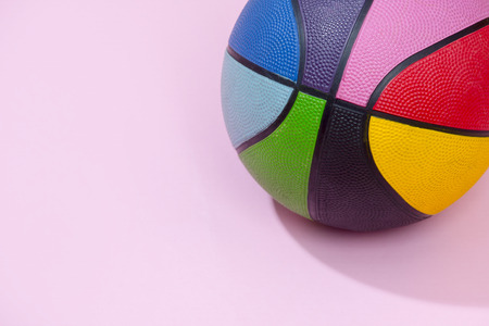 Basketball  on pink background as a sports and fitness symbol of a team leisure activity playing with a leather ball dribbling and passing in competition tournamentsの写真素材