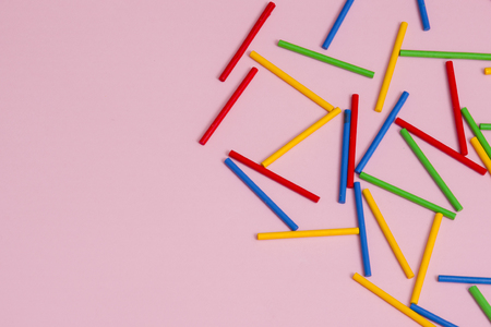 Colorful wooden sticks against pink backgroundの写真素材