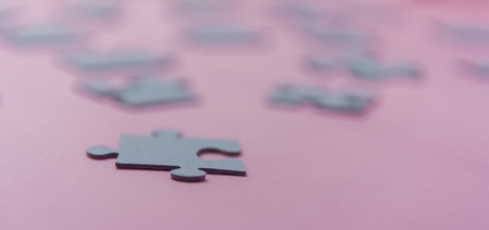 Puzzles on a pink background as a symbol of autism. Conceptual vision of the problem of autistic childrenの写真素材