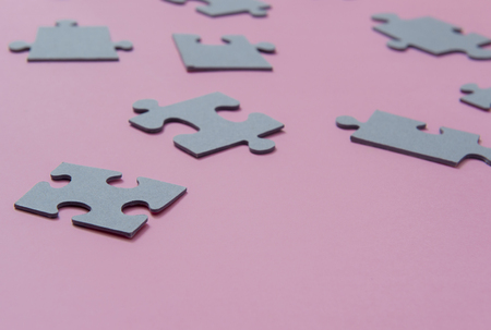 Puzzles on a pink background as a symbol of autism. Conceptual vision of the problem of autistic childrenの写真素材